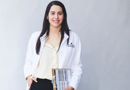 Vivant Skin Care's in-house esthetician Maryanne smiling and holding a clipboard.
