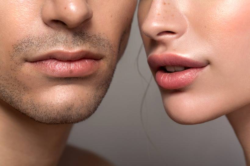 Close shot of woman and man's face, showing their nose and lips.