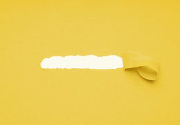 Piece of yellow construction paper torn off