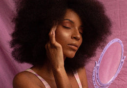 Woman smiling and holding her hair softly