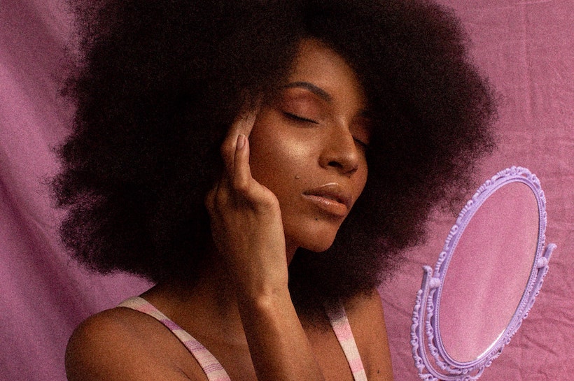 Woman smiling and holding her hair softly